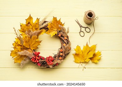 Beautiful Autumn Wreath With Craft Supplies On Color Wooden Background