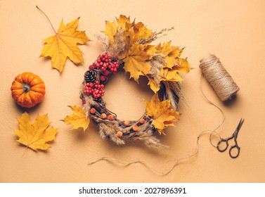 Beautiful Autumn Wreath With Craft Supplies On Color Background