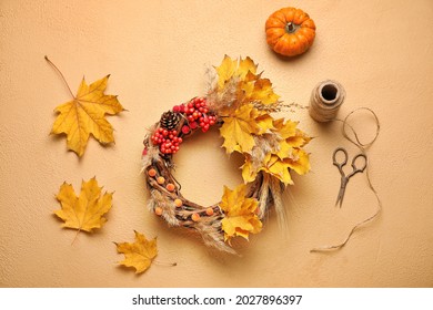 Beautiful Autumn Wreath With Craft Supplies On Color Background