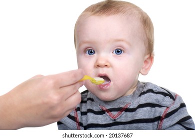 Beautiful Baby Being Feed Rice Cereal With A Yellow Spoon