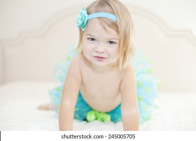 Beautiful Baby With A Blue Tutu And Red Headband 