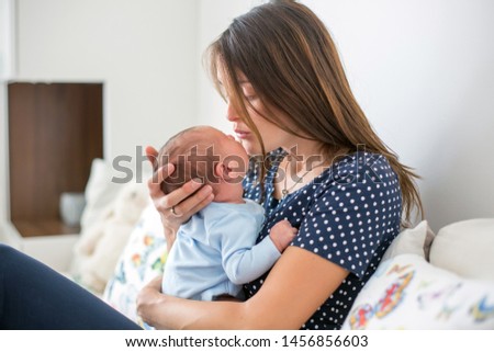 Similar – Image, Stock Photo Mother hugging her baby in front of fireplace