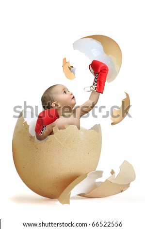 Beautiful baby breaking the egg shell isolated in white