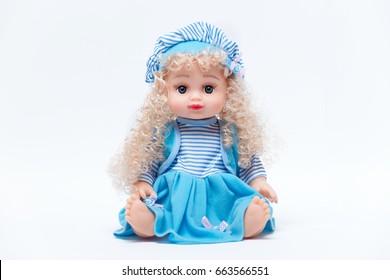 Beautiful baby doll with blond hair in blue dress isolated on white background