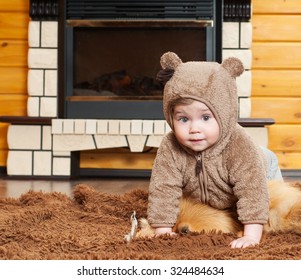 Beautiful Baby In A Fur Hat In The Interior. Winter Season. Warm Clothes.