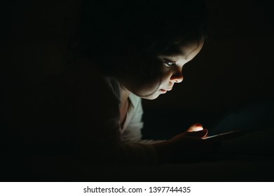 Beautiful Baby Girl Watching Smart Phone Before Sleeping