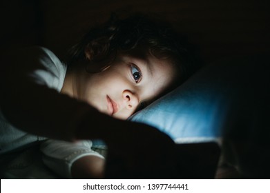 Beautiful Baby Girl Watching Smart Phone Before Sleeping