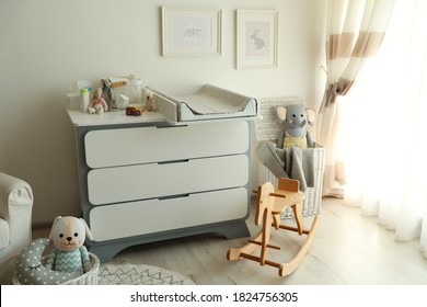 Beautiful Baby Room Interior With Toys And Modern Changing Table