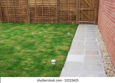 Beautiful Back Yard Garden (green Grass, Wood Fence/door, Stone Pavement, Solar Panel Lights And Brick Wall)