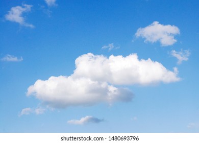 a beautiful background with blue transparent sky air and white fluffy clouds fair weather cumulus humilis on a sunny hot day 