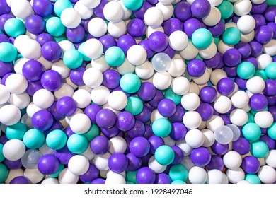 beautiful background with colored plastic balls in the playroom pool. Pool for fun with white and blue balls