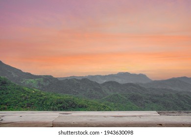 Beautiful Background With Misty Mountains And Empty Wooden Table In Nature Outdoor. Natural Template Landscape