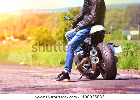 Similar – Couple sitting over motorcycle ready to go