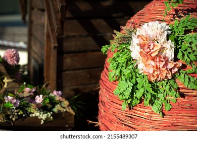 Beautiful Background Of Twigs. Woven Basket With Flower. Street Installation In Spring. Decoration In City.