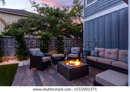 Beautiful backyard firepit at dusk with comfortable chairs