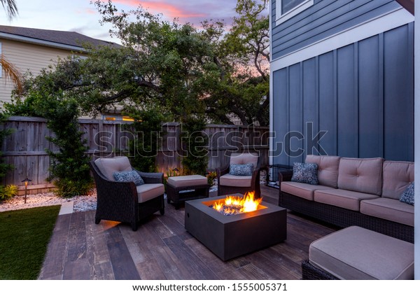 Beautiful backyard firepit at dusk with\
comfortable chairs