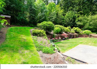 Beautiful Backyard Landscape And Garden View. Garden With Wooden Trim And Stairs