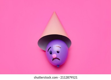 Beautiful Balloon With Drawn Sad Face And Hat On Pink Background