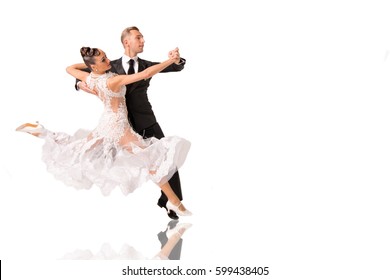 beautiful ballroom dance couple in a dance pose isolated on white background. sensual proffessional dancers dancing walz, tango, slowfox and quickstep