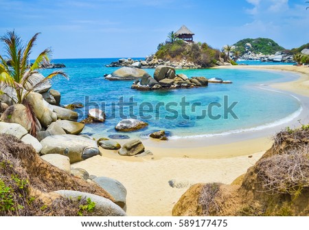 Beautiful bay with white sand beach, blue water and big boulders in Tayrona national park in Colombia with soft focus Stock photo © 