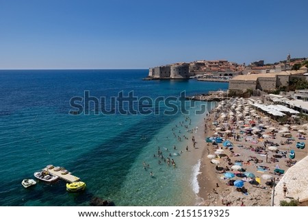 The beautiful beach of Banje with in the back the fortified town of Dubrovnik