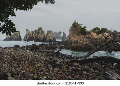 Beautiful Beach With Big Sea Shore Rocks And Sea Waves.