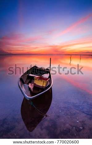 Beautiful beach with fisherman boat during sunrise at Jubakar beach Kelantan, Malaysia. Soft focus due to long exposure. 