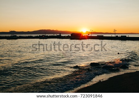 Beautiful beach in Greece while sun rising over the sea, dawn at Aegean Sea