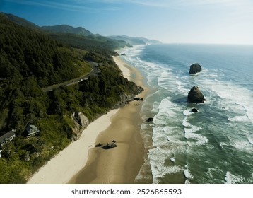 A beautiful beach with a rocky shoreline and a mountain range in the background. The sky is clear and the water is calm - Powered by Shutterstock