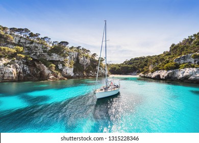 Beautiful beach with sailing boat yacht, Menorca island, Spain. Yachting, travel, summer fun, enjoy life and active lifestyle concept - Powered by Shutterstock