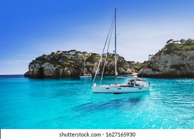 Beautiful beach with sailing boat yacht, Cala Macarelleta, Menorca island, Spain. Yachting, travel, enjoy life, summer fun and active lifestyle concept - Powered by Shutterstock