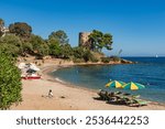 The beautiful beach of Santa Maria Navarrese with the historic old lighthouse, Sardinia, Italy.