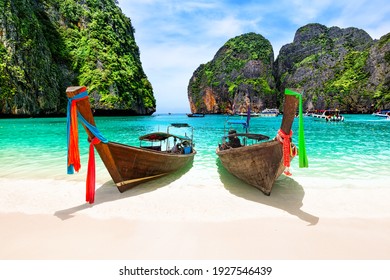 Beautiful beach with thai traditional wooden longtail boat and blue sky in Maya bay, Thailand. Vacation holidays summer background. View of nice tropical beach in Maya bay near Phuket in Thailand. - Shutterstock ID 1927546439