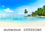 Beautiful beach with white sand, turquoise ocean, green palm trees and blue sky with clouds on Sunny day. Summer tropical landscape, panoramic view.