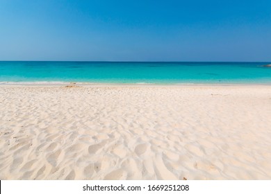 Beautiful Beach With White Sand, Turquoise Ocean Water And Blue Sky. Natural Background For Summer Vacation, Soft Focus.