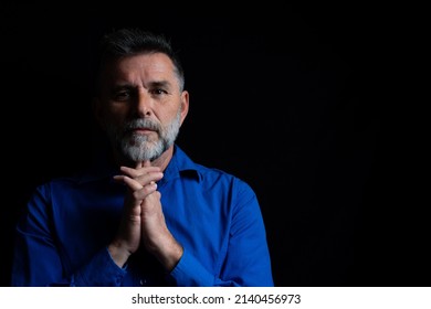 Beautiful bearded handsome man in low key studio. Portrait of a bearded man in a studio environment in front of a black background with dramatic low key lights. - Powered by Shutterstock