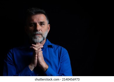 Beautiful Bearded Handsome Man In Low Key Studio. Portrait Of A Bearded Man In A Studio Environment In Front Of A Black Background With Dramatic Low Key Lights.