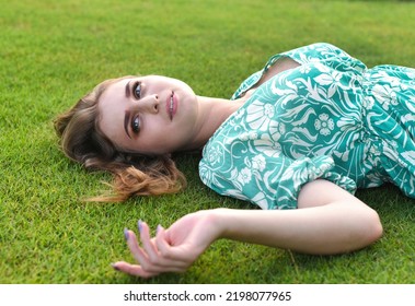 Beautiful Belarus Woman Laying On The Grass 