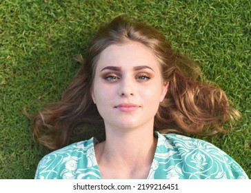 Beautiful Belarus Woman Laying On The Grass 