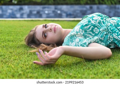 Beautiful Belarus Woman Laying On The Grass 