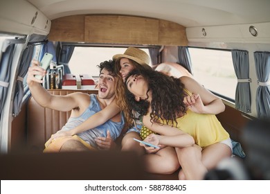 Beautiful best friends taking selfies smart phone vintage camper van retro style social media smiling having fun - Powered by Shutterstock