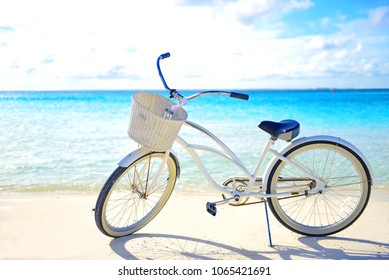 Beautiful bicycle on the clear beach with blue sky and ocean - Powered by Shutterstock