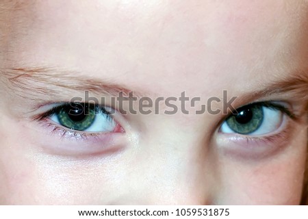 beautiful big green eyes of the young girl. Close-up