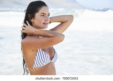Beautiful bikini babe in the sea, looking away