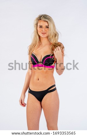 Beautiful bikini model posing in a studio environment