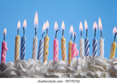 beautiful birthday candles on blue background
