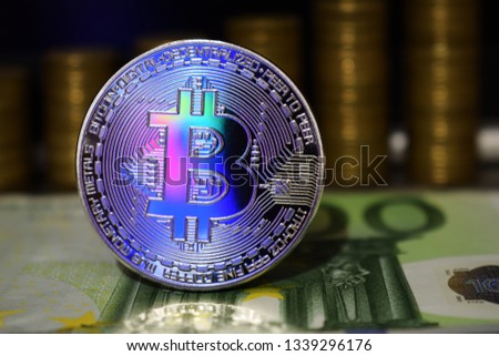 Beautiful Bitcoin BTC on the background of euro banknote and gold coins.