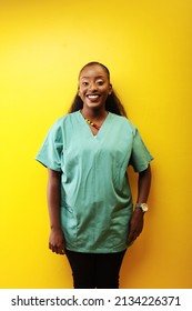 beautiful black african woman nurse smiling in a studio wearing scrubs