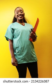 beautiful black african woman nurse smiling in a studio wearing scrubs
