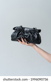 Beautiful Black Bag In Hand On A White Background.